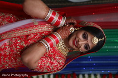 Indian bride putting on her earings. Indian bride putting on her earings.