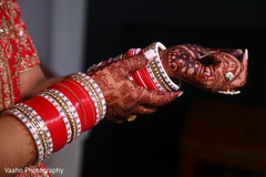 Indian bride putting on her wedding ceremony bangles. Indian bride putting on her wedding ceremony bangles.