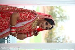 Indian bride wearing her ceremony red and golden lehenga. Indian bride wearing her ceremony red and golden lehenga.