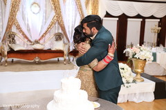 Indian couple at wedding reception cutting cake moment. Indian couple at wedding reception cutting cake moment.