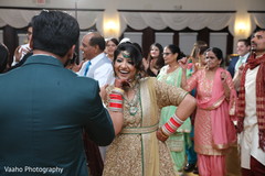 Indian bride posing in her golden and green reception gown. Indian bride posing in her golden and green reception gown.