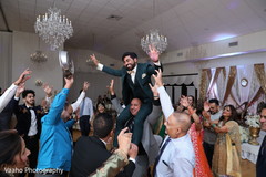 Indian groom lifted at wedding reception party. Indian groom lifted at wedding reception party.