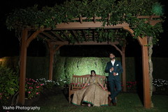 Indian couple posing outdoors in a pergola. Indian couple posing outdoors in a pergola.