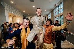 Indian groom lifted by groomsmen at baraat party. Indian groom lifted by groomsmen at baraat party.
