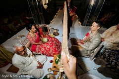 Indian bride and groom holding coconuts behind antarpat. Indian bride and groom holding coconuts behind antarpat.