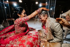 Indian bide pouring rice to groom's head ritual. Indian bide pouring rice to groom's head ritual.
