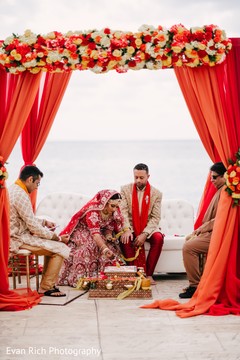 Indian bride pouring offerings to the sacred fire. Indian bride pouring offerings to the sacred fire.