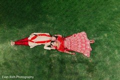 Indian bride and groom laying on the grass capture. Indian bride and groom laying on the grass capture.