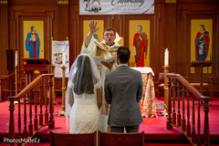 Bride and groom receiving the blessing from the priest Bride and groom receiving the blessing from the priest