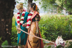 Indian lovebirds holding hands and walking their dog. Indian lovebirds holding hands and walking their dog.