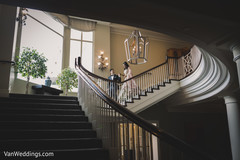 Indian bride and groom holding hands while walking down the stairs. Indian bride and groom holding hands while walking down the stairs.