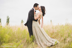 Lovely Indian groom kissing bride during the outdoor photo session. Lovely Indian groom kissing bride during the outdoor photo session.