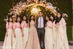 Indian couple with bridesmaids on their reception outfits. Indian couple with bridesmaids on their reception outfits.
