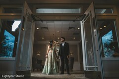 Indian couple posing between reception doors. Indian couple posing between reception doors.