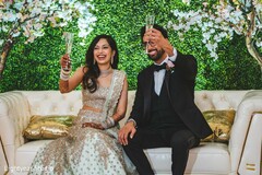 Indian couple having a toast at the Indian wedding reception. Indian couple having a toast at the Indian wedding reception.