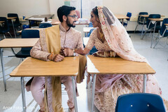 Indian couple possing on desks. Indian couple possing on desks.