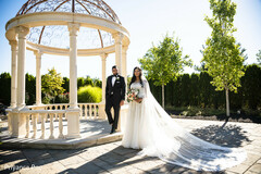 Indian couple posing outdoors on their wedding outfits. Indian couple posing outdoors on their wedding outfits.