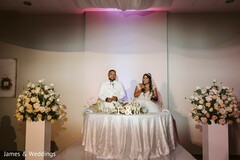 Indian couple at their wedding reception table. Indian couple at their wedding reception table.
