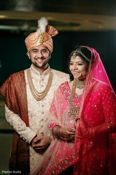 Indian couple posing with their wedding ceremony outfits. Indian couple posing with their wedding ceremony outfits.