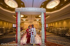 Indian couple posing at the wedding ceremony entrance. Indian couple posing at the wedding ceremony entrance.