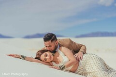 Indian bride and groom laying on white sand. Indian bride and groom laying on white sand.