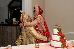 Indian bride and groom cutting cake moment. Indian bride and groom cutting cake moment.
