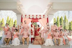 Indian couple posing with bridesmaids and groomsmen at the mandap. Indian couple posing with bridesmaids and groomsmen at the mandap.