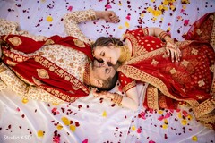 Indian couple on their red and golden wedding outfits. Indian couple on their red and golden wedding outfits.
