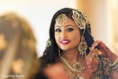 Indian bride putting her wedding jewelry on. Indian bride putting her wedding jewelry on.