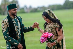 Indian couple posing outdoors on their green wedding outfits. Indian couple posing outdoors on their green wedding outfits.
