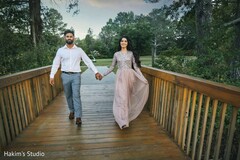 Lovely bride and groom holding hands at their engagement photoshoot. Lovely bride and groom holding hands at their engagement photoshoot.