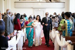 Glamorous Indian bride walking in with parents Glamorous Indian bride walking in with parents