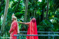 Gorgeous Indian bride and groom in ruby traditional outfits. Gorgeous Indian bride and groom in ruby traditional outfits.
