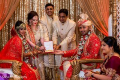 Lovely Indian bride and groom posing with guests for a portrait. Lovely Indian bride and groom posing with guests for a portrait.