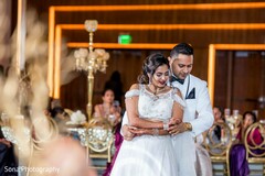 Dazzling Indian bride and groom holding each other. Dazzling Indian bride and groom holding each other.