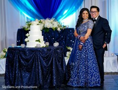 Marvelous Indian couple posing with their wedding cake magical scene Marvelous Indian couple posing with their wedding cake magical scene