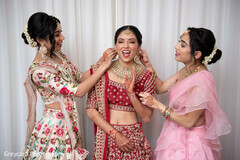 Charming indian bride and bridesmaids getting ready scene Charming indian bride and bridesmaids getting ready scene