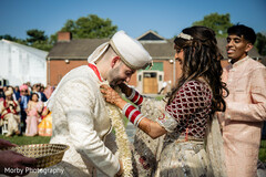 Indian bride putting flower garland to groom Indian bride putting flower garland to groom