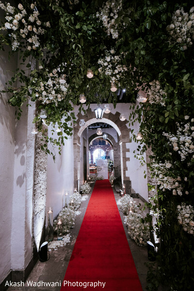 floral decoration,red carpet,pathway,archway,wedding decor,elegant entrance,romantic