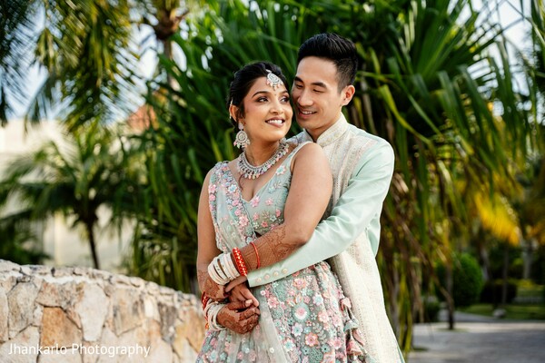 couple embrace,lush greenery,romantic moment,bride and groom,tropical wedding,outdoor love