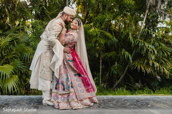 elegant couple portrait,coordinated wedding attire,south asian bridal style,regal groom look,lush green backdrop