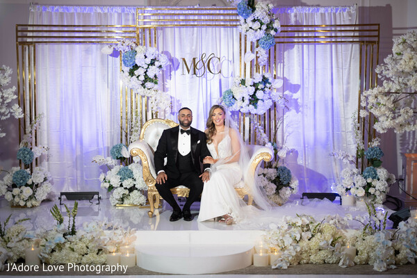 wedding reception,luxurious setup,floral elegance,gold and white theme,newlywed bliss,romantic ambiance