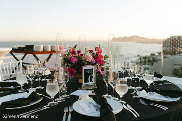 elegant tablescape,oceanfront wedding,sunset reception,luxury decor,floral elegance,stylish setup,romantic evening