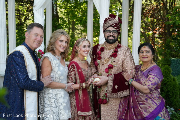 family portrait,multicultural wedding,south asian groom,western bride,traditional attire,wedding elegance