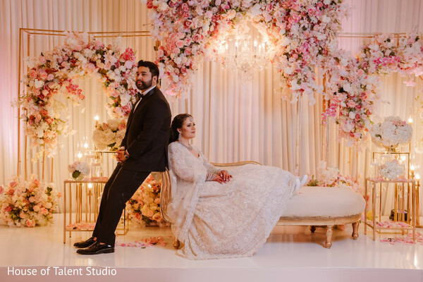 wedding reception,playful couple,newlyweds,romantic setup,luxury decor,south asian wedding