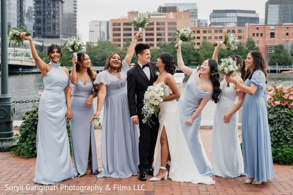 bridal party photo,blue bridesmaid dresses,waterfront wedding,fun group shot,joyful wedding moment