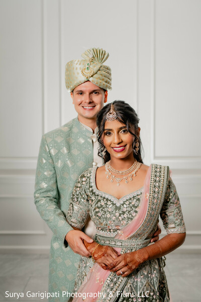 pastel wedding outfits,indian bride and groom,coordinated couple attire,south asian wedding portrait