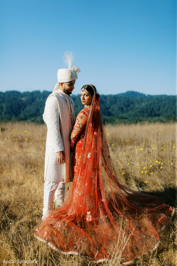 outdoor wedding portrait,indian couple shoot,red bridal dupatta,groom in sherwani,cinematic wedding photo