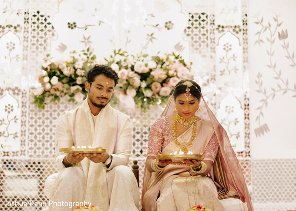 diya ceremony,bride and groom,floral mandap,soft wedding tones,traditional ritual,indian wedding ceremony