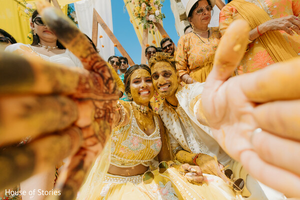 haldi couple moment,candid turmeric shot,playful wedding portrait,indian wedding rituals,yellow pre-wedding fun